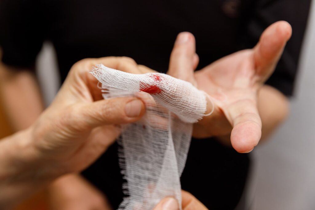Applying a bandage to the wound of a man's finger. The man neglected precautions and cut his hand. Domestic trauma. Work injury.