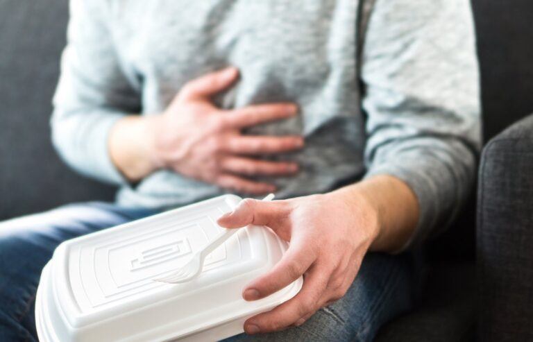 Man having diarrhea or food poisoning after unhealthy junk fast food. Guy has to go to toilet after eating too much. Stomach pain, digestion problem, indigestion, salmonella or heart attack