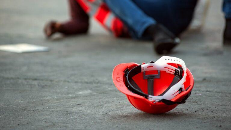 Helmet on ground near hurt worker