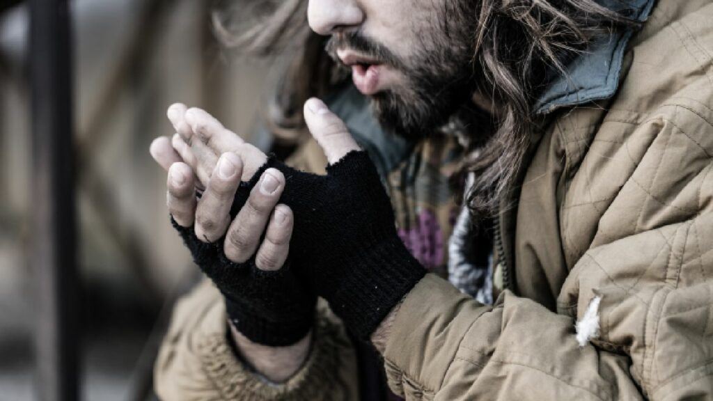 Man breathing on hands