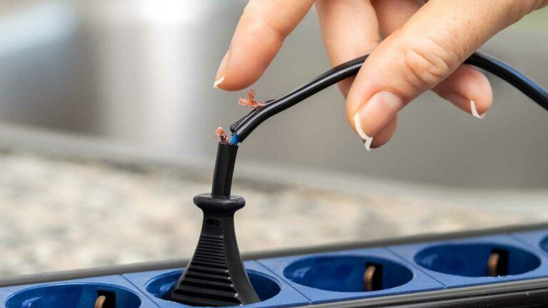 person touching electrical wire