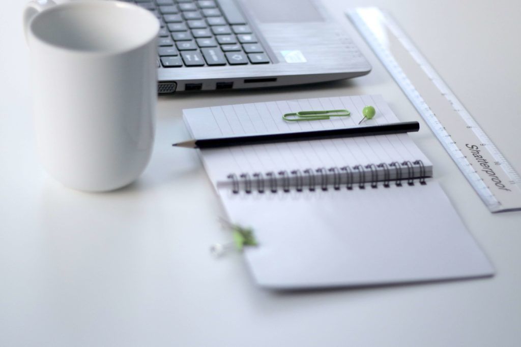 notepad, computer and desk